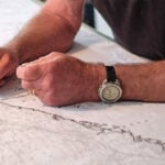 man's hands drawing a map