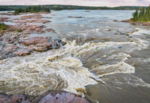 whitewater kayakers paddle into the Mountain Portage Rapids on the Slave River