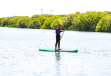 a man paddles a cheap standup paddleboard