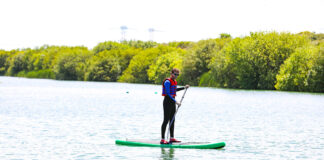 a man paddles a cheap standup paddleboard