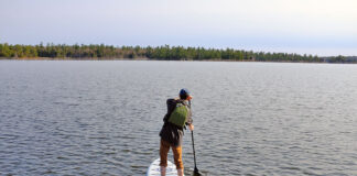 man stands and paddles the ISLE Pioneer 2.0 standup paddleboard