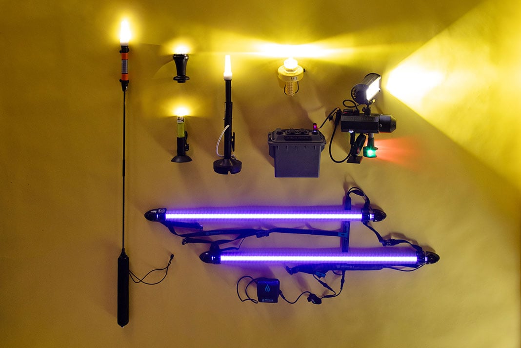 a selection of kayak lights laid out on a yellow backdrop