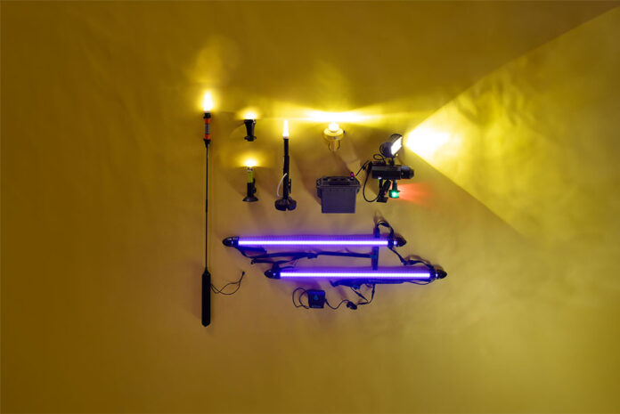a selection of kayak lights laid out on a yellow backdrop