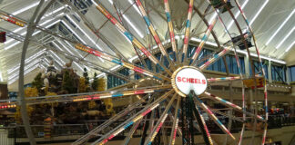 an indoor ferris wheel at a Scheels store where kayaks are sold