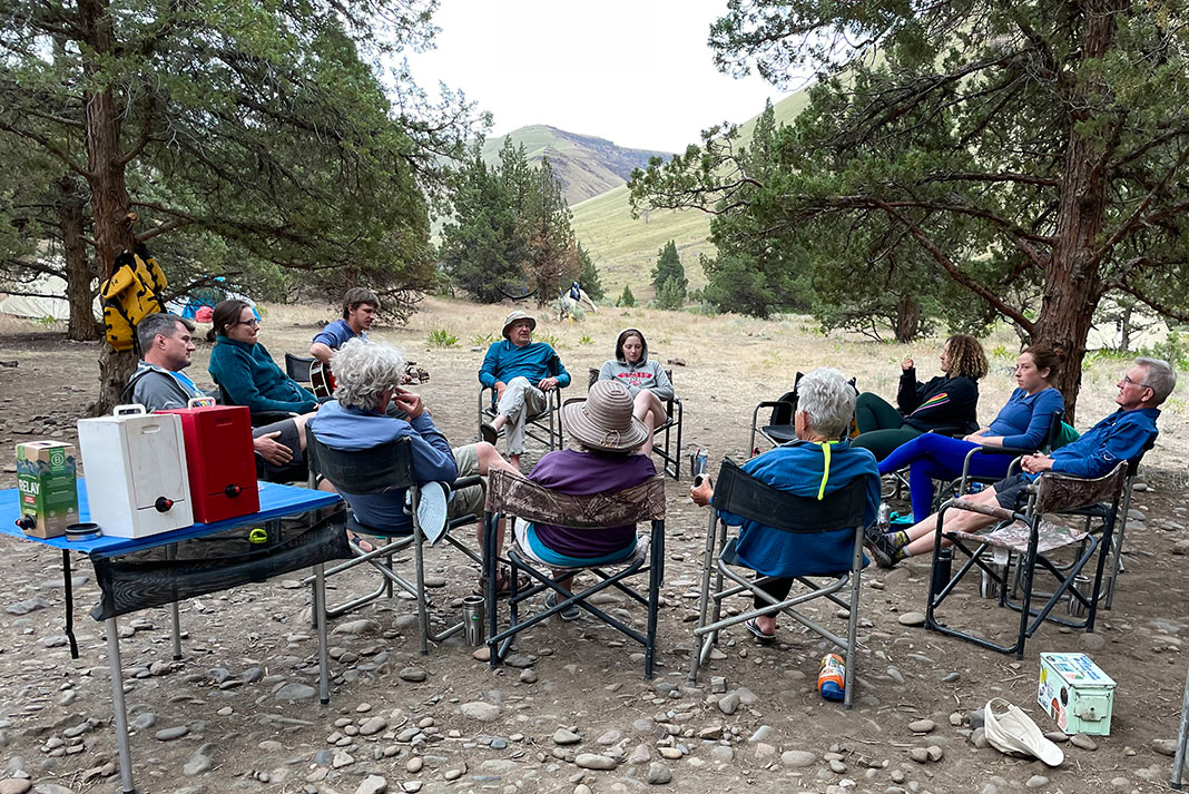 a group of rafters relax at camp with Oregon River Experiences