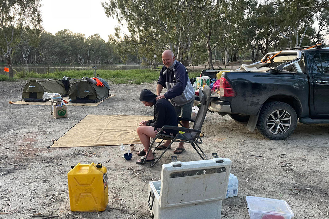 members of Dave Alley's support team help him during a stop in the expedition