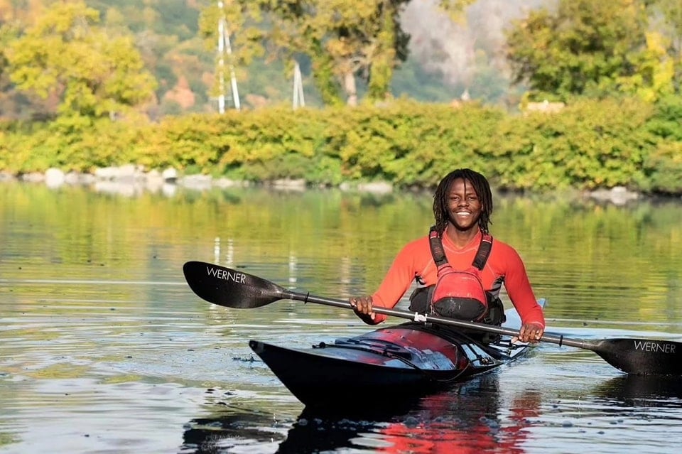 Kayaker on calm water.