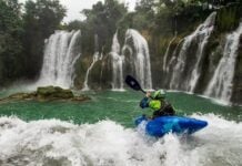 A Jackson Kayak paddler using a Werner Paddle as they go over a waterfall.