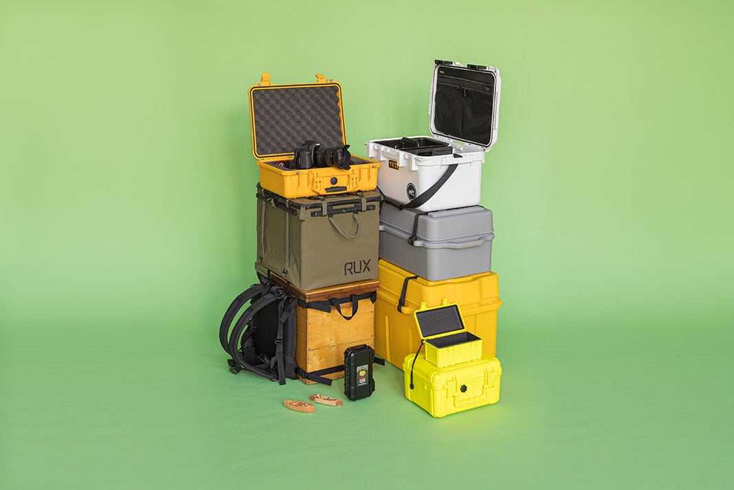 an arrangement of 9 different camping gear boxes on a green background