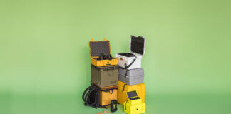 an arrangement of 9 different camping gear boxes on a green background