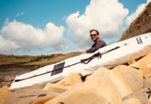 David Haze poses with his homemade standup paddleboard