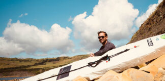 David Haze poses with his homemade standup paddleboard