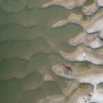 Source To Sea On The Lifeline Of India overhead view of a kayak resting on sand dunes on the banks of India's Ganges River