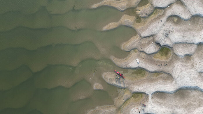overhead view of a kayak resting on sand dunes on the banks of India's Ganges River
