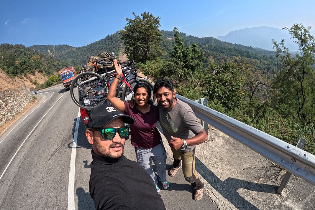 Rency Thomas poses for a photo with his team on the roadside in India