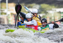 a group of paddlers compete in kayak cross in advance of its Olympics debut