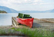 red tripping canoe sits loaded on a dock along the Columbia River