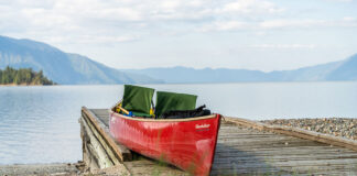 red tripping canoe sits loaded on a dock along the Columbia River