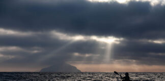 silhouetted view of Freya Hoffmeister on one of her greatest kayaking expeditions