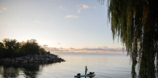 Dan Rubinstein stands silhouetted on his paddleboard during a SUP expedition that would teach him many paddling life lessons