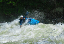 a whitewater kayaker paddles through rapids after satisfying the pre-run superstitions he observes