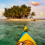 Frank Wolf Rounds The Darien Gap two sea kayakers approach a small island in the Darien Gap