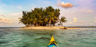 two sea kayakers approach a small island in the Darien Gap