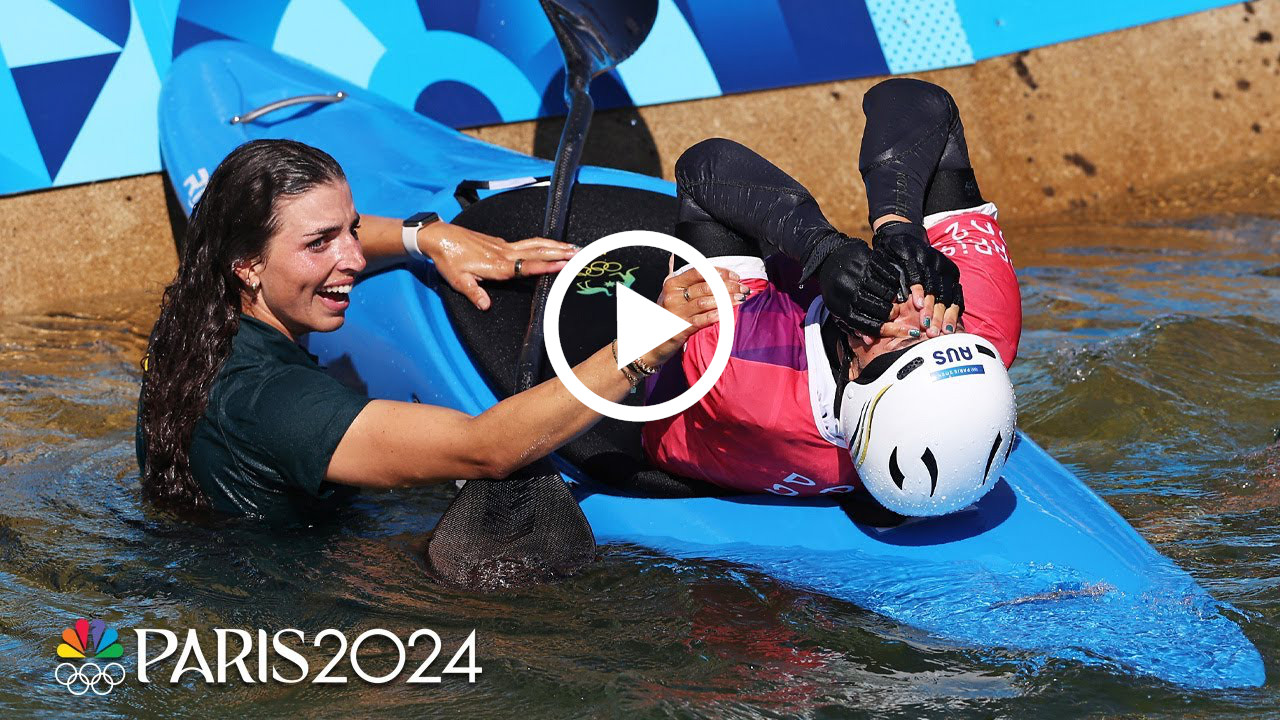 Jessica fox embraces sister Noemie Fox after she wins gold in Olympic kayak cross.