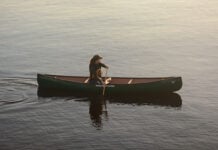 woman paddles the Nova Craft Canoe Prospector 14 solo canoe