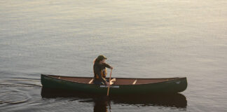 woman paddles the Nova Craft Canoe Prospector 14 solo canoe