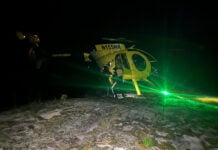 image of Grace Zeller's helicopter landing on a rock shelf in the dark in the Boundary Waters Canoe Area Wilderness courtesy of Tony Maynard, a bystander on scene of the canoe rescue in the BWCAW