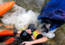 Whitewater kayaker being pulled out of a sieve during rescue on Linville River.