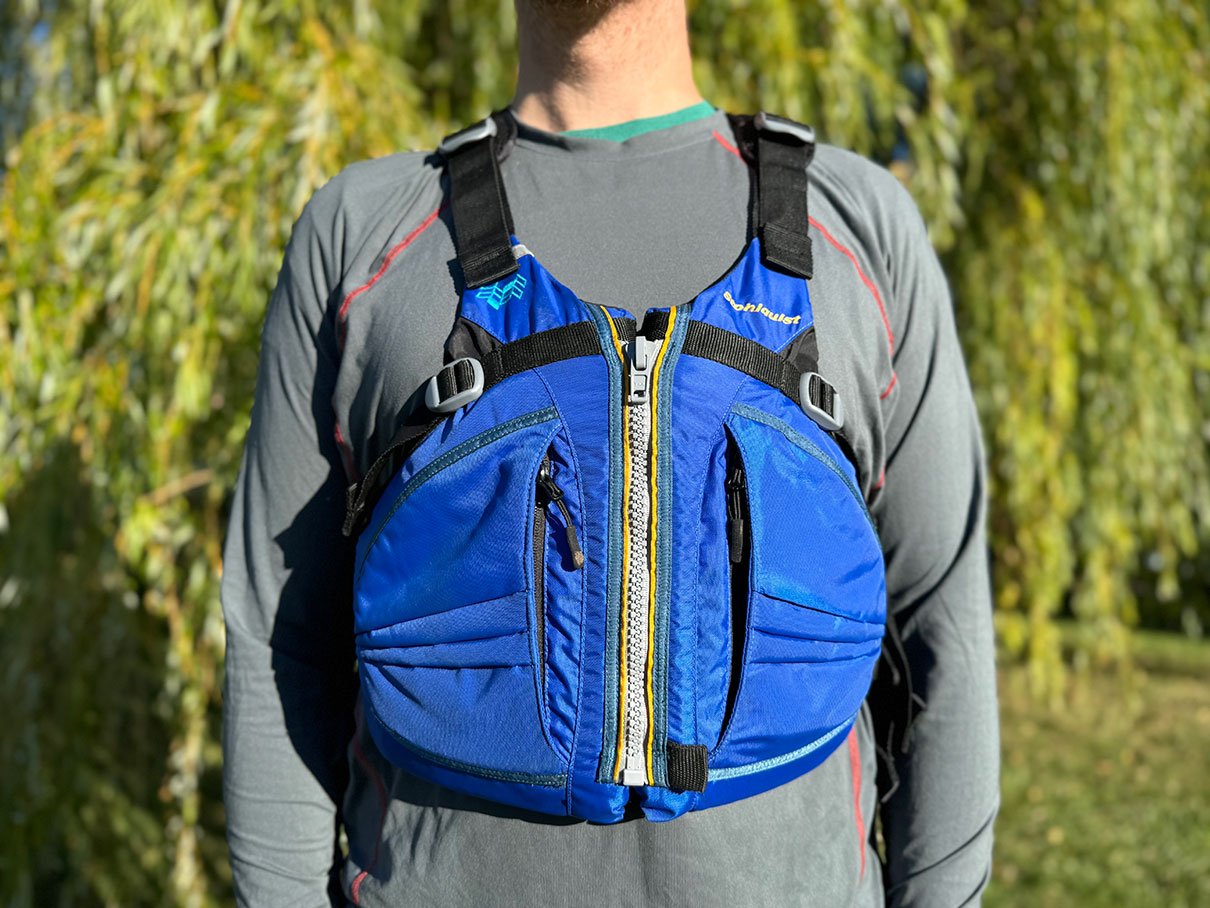 man poses while wearing the Stohlquist Trekker life jacket