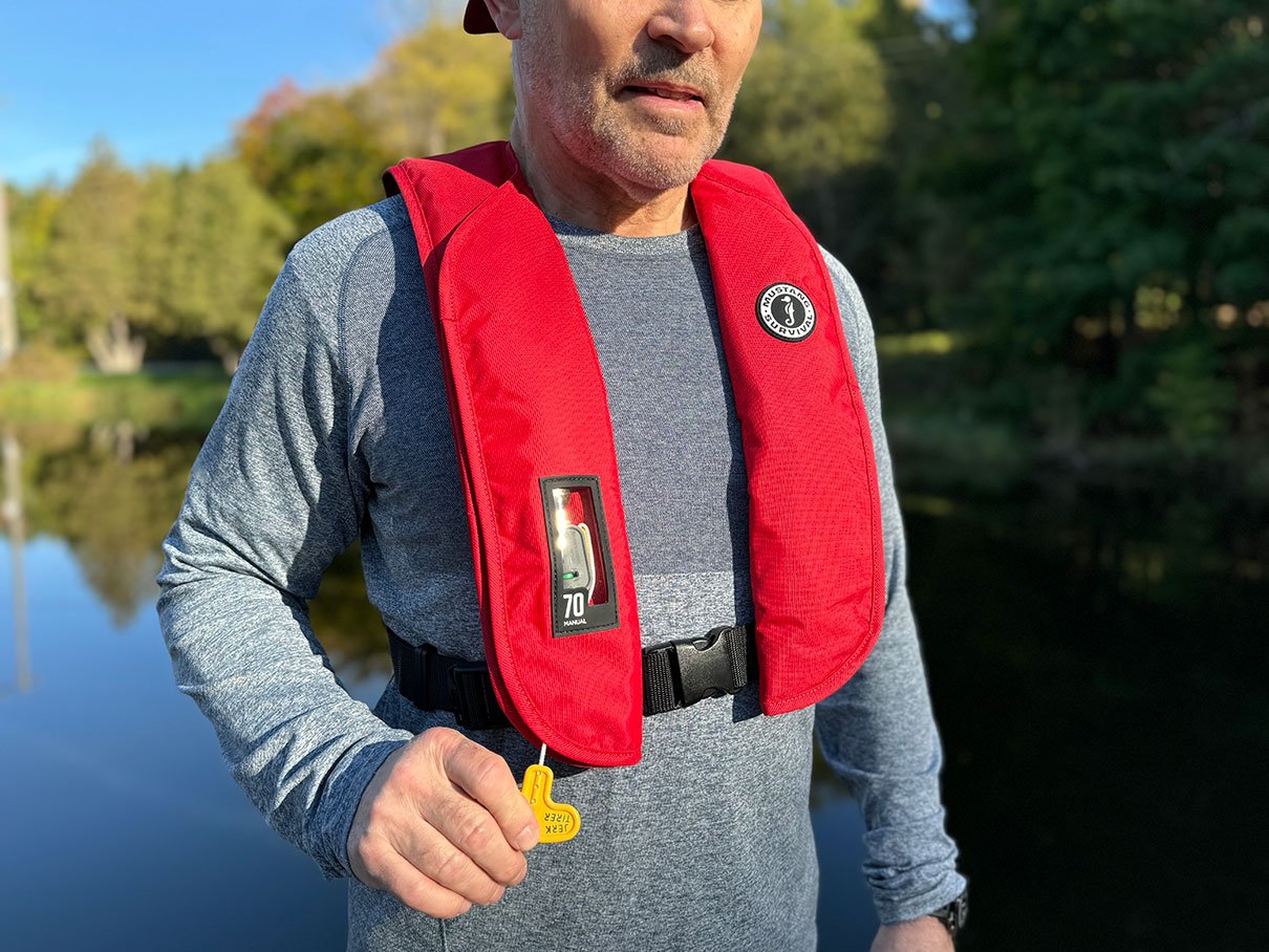 man poses while wearing the Mustang MIT 70 inflatable life vest