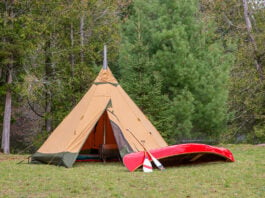 a luxury wilderness camping tent from Tentipi with high-end canoe and paddle