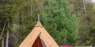 a luxury wilderness camping tent from Tentipi with high-end canoe and paddle