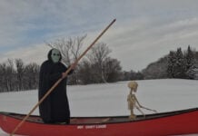 Halloween costume dress up in a canoe on a frozen river