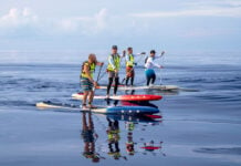 a group of SUP endurance paddles, including double-lung transplant recipient Scott Johnson, subject of a new documentary