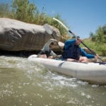Paddling Magazine digital editor Joe Potoczak paddles an inflatable tandem kayak with a friend