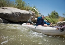 Paddling Magazine digital editor Joe Potoczak paddles an inflatable tandem kayak with a friend