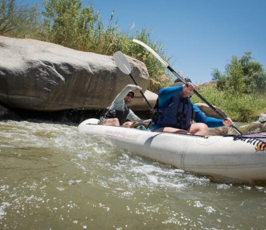 Paddling Magazine digital editor Joe Potoczak paddles an inflatable tandem kayak with a friend