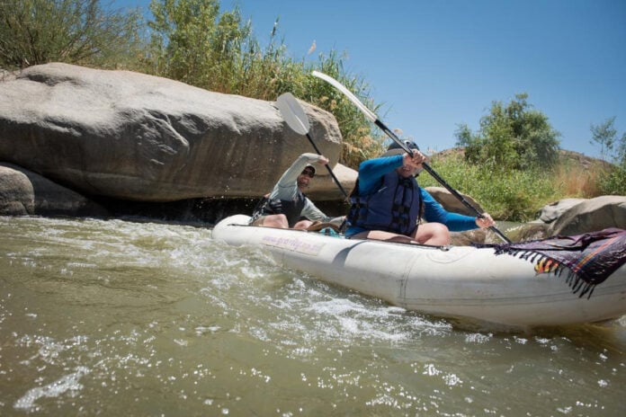 Paddling Magazine digital editor Joe Potoczak paddles an inflatable tandem kayak with a friend