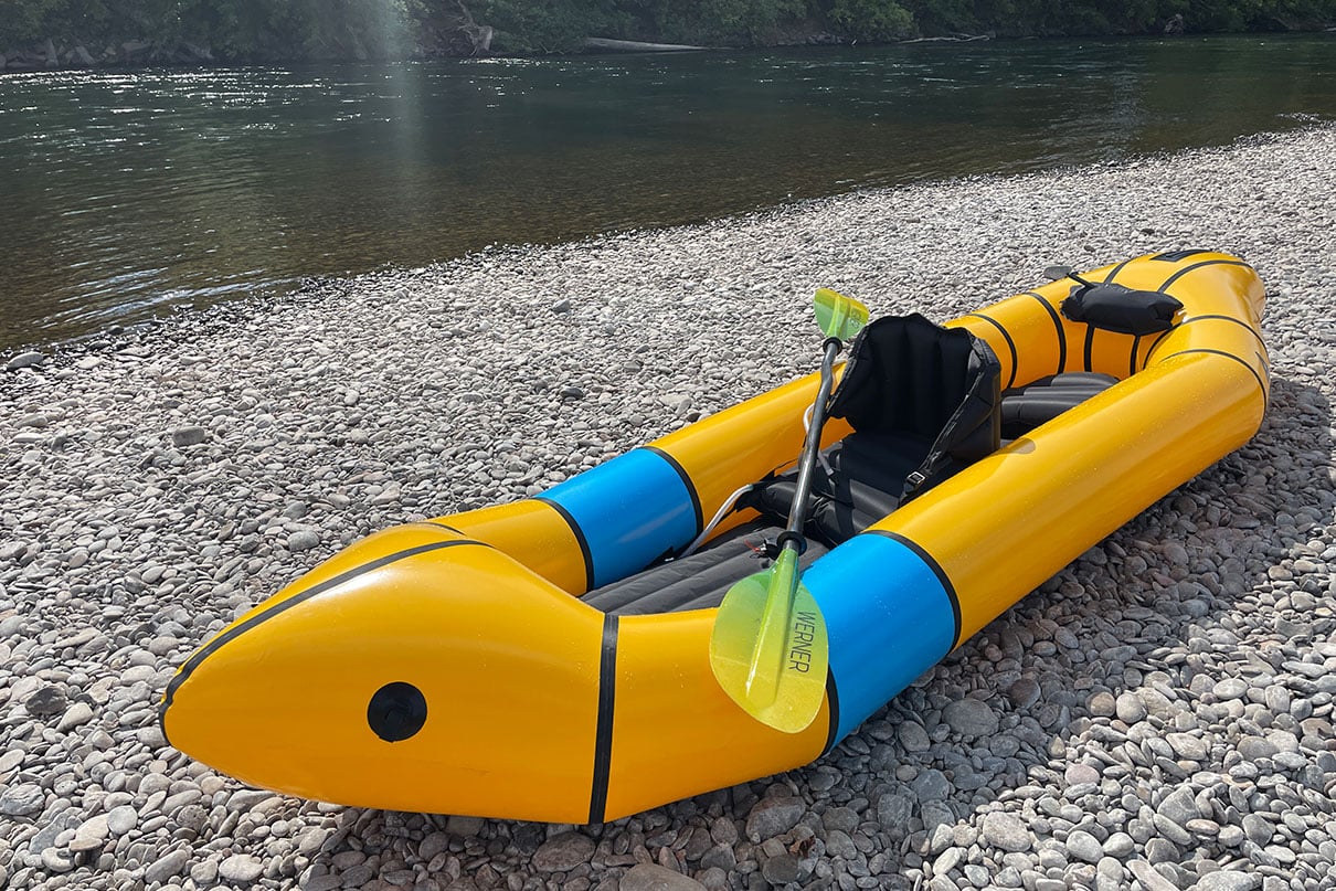 Alpacka Tango tandem inflatable packraft sits on a pebbly riverbank