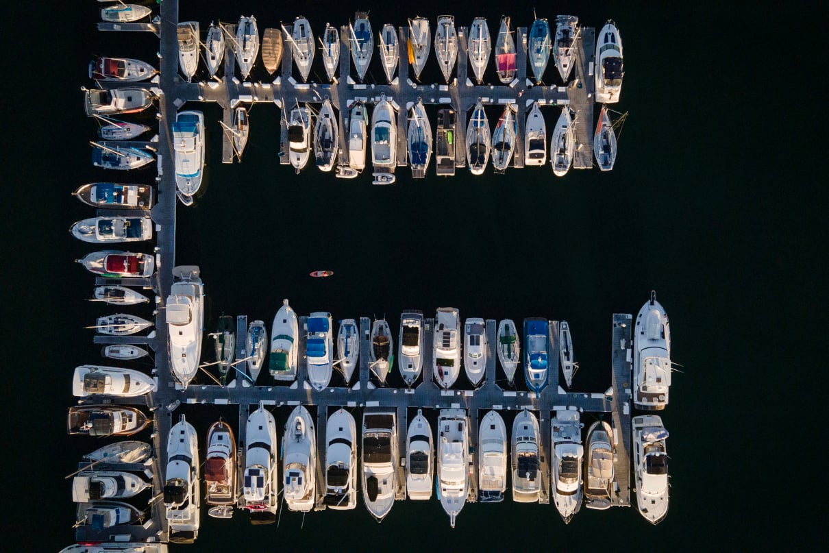 Paddleboard among boats at a marina in San Diego.