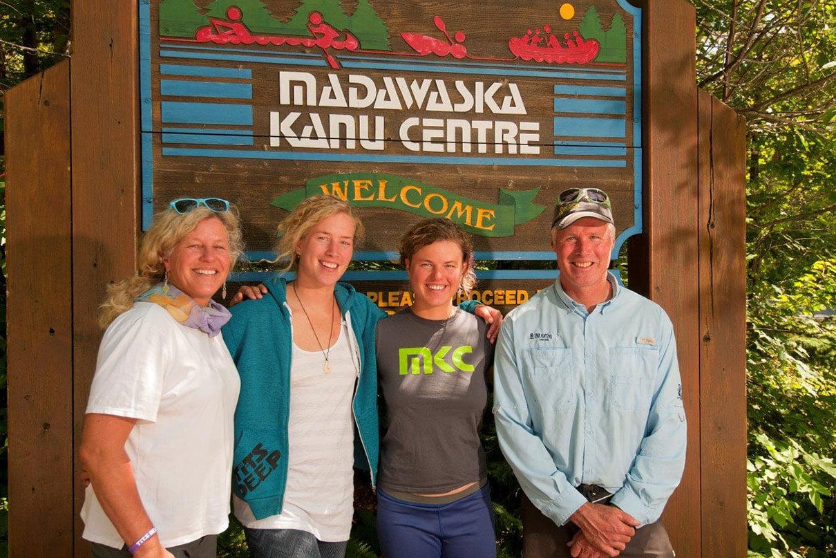The Kerckhoff - van Wijk clan pose in front of wooden Madawaska Kanu Centre sign