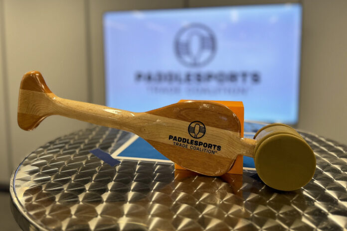 PTC gavel in front of a slide show of the Paddlesports Trade Commision.