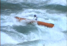 Image of Nolan Whitesell in an open canoe in the Niagara Gorge Rapids