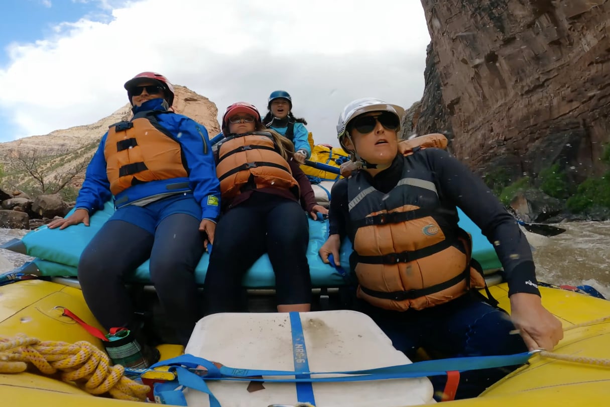 Group of rafters looking forward as they enter a rapid.