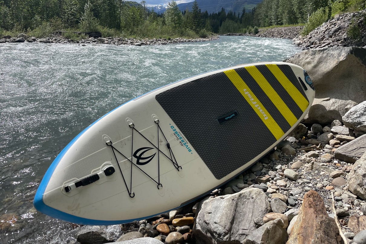 Badfish Rivershred whitewater SUP beside a river