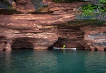 A kayaker explores the sea caves on Sand Island in the Apostle Islands National Lakeshore near Bayfield, Wisconsin. Image: Maddy Marquardt